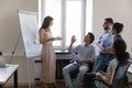 Business teacher woman giving presentation to diverse interns Royalty Free Stock Photo