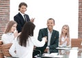 Business team applauding business partners after signing the contract. Royalty Free Stock Photo