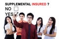Business team approving supplemental insured