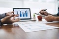 Business team casual collaboration discussing working analysis with financial data and marketing growth report graph in team, Royalty Free Stock Photo