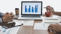 Business team casual collaboration discussing working analysis with financial data and marketing growth report graph in team, Royalty Free Stock Photo