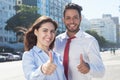 Business team in the city showing thumb up Royalty Free Stock Photo