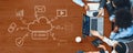 Business Team Collaborating on Cloud Computing Concepts with Digital Graphics and Technology Illustrations on Wooden Royalty Free Stock Photo