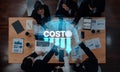 Business Team Collaborating on Financial Reports and Analyzing Cost Reduction Strategies with Graphs and Data Royalty Free Stock Photo