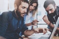 Business team concept.Young professionals discussing new business project in modern office.Group of three people analyze Royalty Free Stock Photo