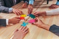 Business team connect pieces of puzzle like a teamwork and partners Royalty Free Stock Photo