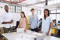 Business team at desk in an office look to camera, close up Royalty Free Stock Photo