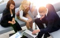 Business team discussing financial documents sitting in the lobby of the office Royalty Free Stock Photo