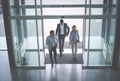 Business team gets to work. Three people entering the building. Royalty Free Stock Photo