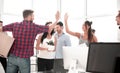 Business team is giving each other a high five in the new office Royalty Free Stock Photo