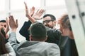 Business team giving each other high five in new office. Royalty Free Stock Photo