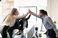 Business team giving high fives in office Royalty Free Stock Photo