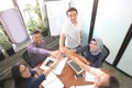 Business team giving highfive together at the office meeting room with laptop smartphone and tablet near windows with white board Royalty Free Stock Photo