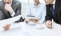 Business team with graph, tablet pc and coffee Royalty Free Stock Photo