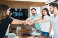 Business Team With Hands Stacked Together In Meeting