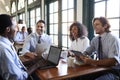 Business Team Having Informal Meeting Around Table In Coffee Shop