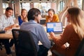 Business Team Having Meeting Sitting Around Table In Modern Open Plan Office Royalty Free Stock Photo