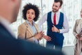 Business team having a meeting standing in the office. Royalty Free Stock Photo