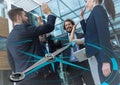 Business team high fiving and compass graphic Royalty Free Stock Photo