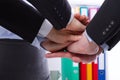 Business team holding hands together at the office. Selective focus and macro Royalty Free Stock Photo