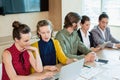 Business team interacting with each other in conference room Royalty Free Stock Photo