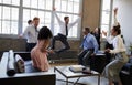 Business team jump for joy at hitting target in meeting Royalty Free Stock Photo