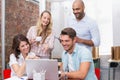 Business team laughing together in front of the laptop Royalty Free Stock Photo