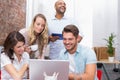 Business team laughing together in front of the laptop Royalty Free Stock Photo