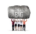 Business team lifting text of dream big