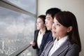 Business team look city through window