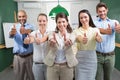 Business team looking at camera and giving thumbs up Royalty Free Stock Photo