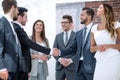 Business team looks at the handshake of business partners