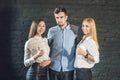 business team male and female formed of young businessmen standing over a dark background