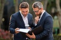 Business team. Offering deal, discussing new project. Two businessmen discussing outdoor. Two business people talk. Two Royalty Free Stock Photo