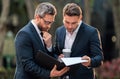 Business team. Offering deal, discussing new project. Two businessmen discussing outdoor. Two business people talk. Two Royalty Free Stock Photo