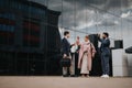 Business team outside office building discussing strategies and ideas Royalty Free Stock Photo