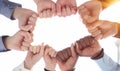 Business team or partners put fists in circle as concept of motivating engaging teambuilding activity