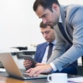 Business team remotely solving a problem at business meeting using laptop computer and touchpad.