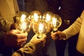 Business team holding light bulbs, sharing creative energy and developing new ideas Royalty Free Stock Photo