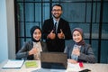 business team showing thumb up while sitting at the office Royalty Free Stock Photo