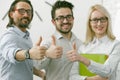 Business Team showing thumbs up gesture. Office workers expressing a positive mood is showing a thumb up sign meaning