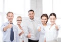 Business team showing thumbs up in office Royalty Free Stock Photo