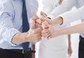 Business team showing thumbs up in office