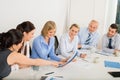 Business Team Sitting Around Meeting Table