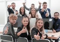 Business team sitting at a Desk and showing thumbs up