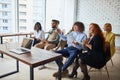 Young diversity team of employees listening to business coach on training in office Royalty Free Stock Photo