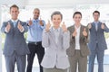 Business team smiling at camera showing thumbs up Royalty Free Stock Photo