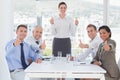 Business team smiling at camera showing thumbs up Royalty Free Stock Photo