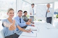 Business team smiling at camera showing thumbs up Royalty Free Stock Photo