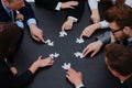 Business team solving puzzle together. Royalty Free Stock Photo